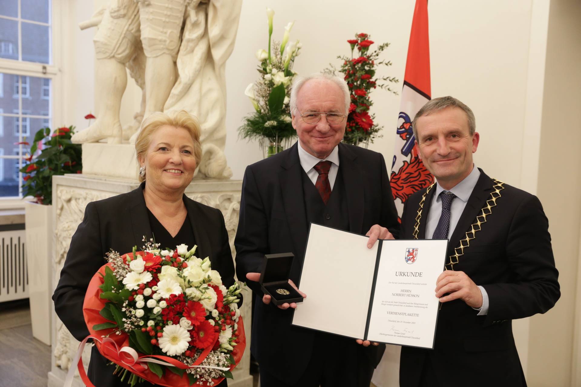  Oberbürgermeister Thomas Geisel überreichte Norbert Hüsson die Verdienstplakette. Mit im Bild Ehefrau Dr. Andrea Hüsson. Foto: Stadt/ Ingo Lammert 