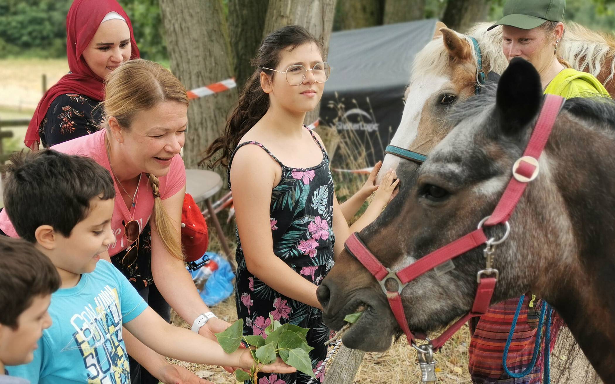  Western- und Pferdetrainerin Svenja Clauberg (3. v. l.) führt die Kinder vorsichtig an den ersten Pferdekontakt heran.  