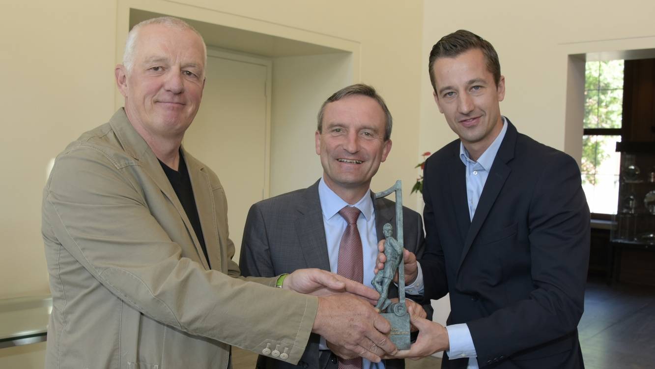  Künstler Till Hausmann (li.) und Denkmal-Initiator Björn Borgerding überreichen Oberbürgermeister Thomas Geisel die Denkmalminiatur. 