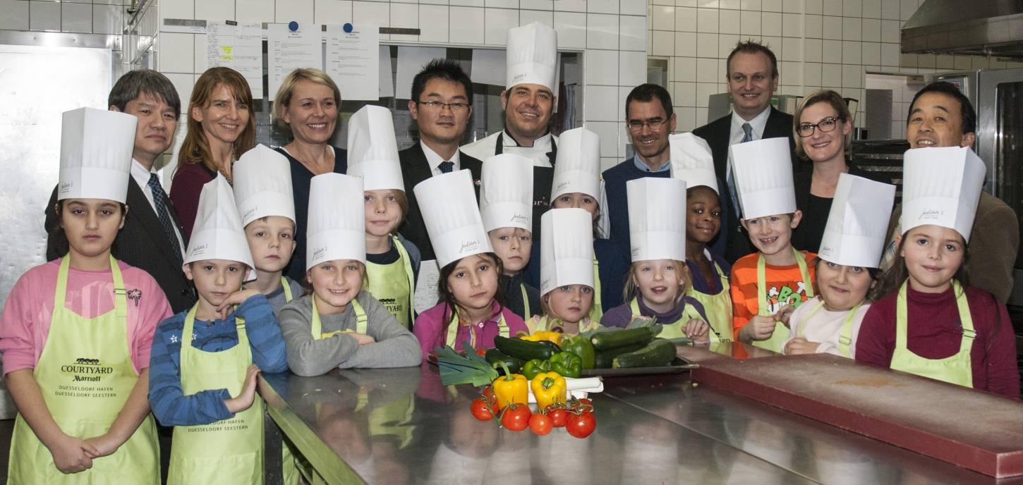  Schüler der St. Rochus-Schule mit Chefkoch Andreas Huber, SMS-Projektleiter Professor Karsten Müssig und einer Delegation aus dem Ministerium in der Präfektur Chiba beim Kochkursus im Hotel Courtyard by Marriott Düsseldorf Seestern. 